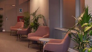A waiting area with chairs and a reception desk. - Heeton Concept Hotel City Centre Liverpool (Liverpool)