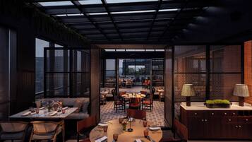 A modern dining area with a high ceiling, open space, and a view of the cityscape.