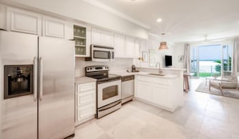 Brand New Two King Bay Front | Private kitchen | Full-size fridge, microwave, oven, stovetop at Bayside Villas by Islander Resort