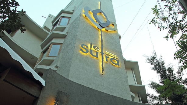 Un edificio con un letrero llamativo que dice "Shiva" y un gran emblema circular.