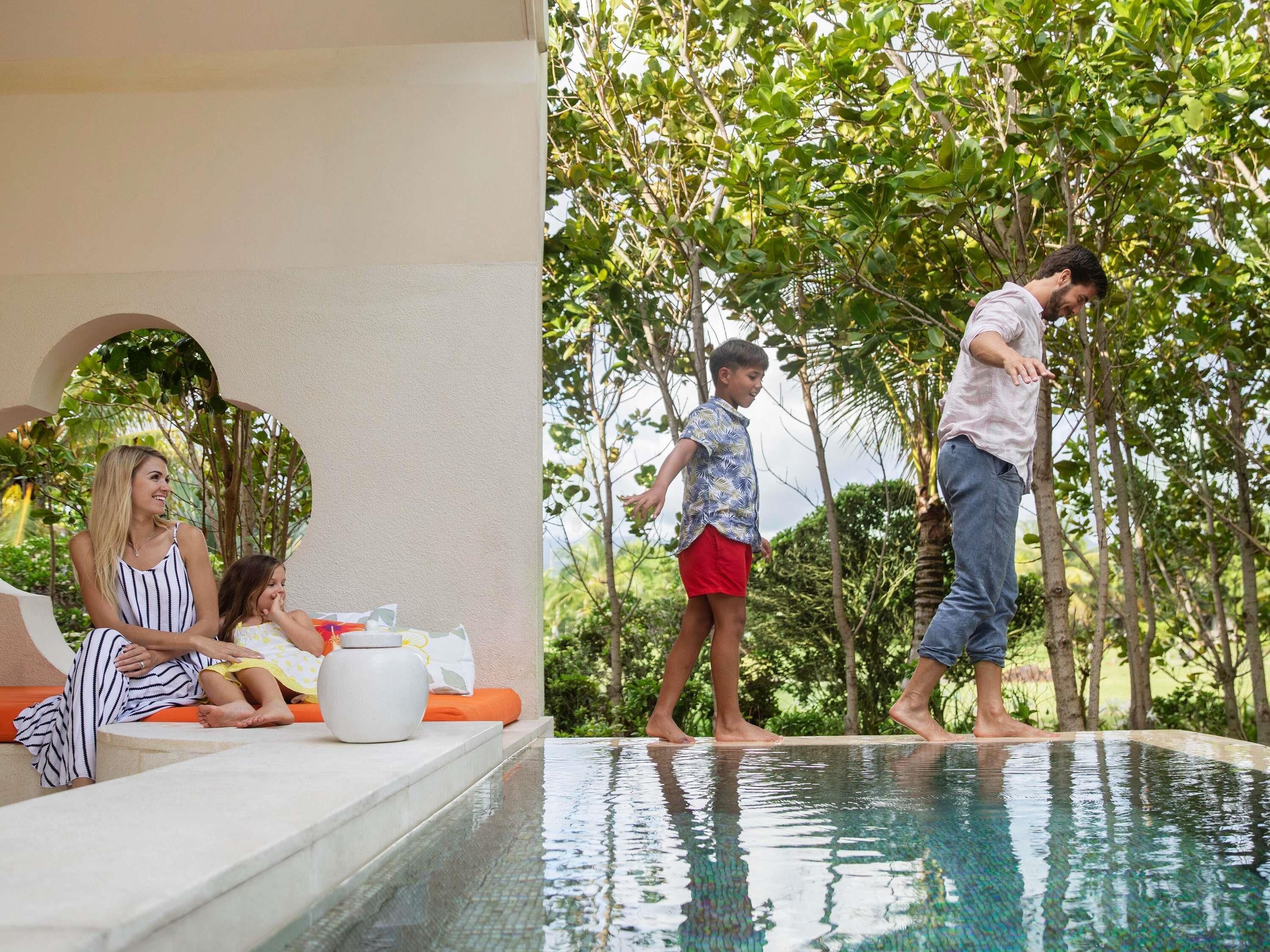 A poolside area with a seating arrangement and a pool.