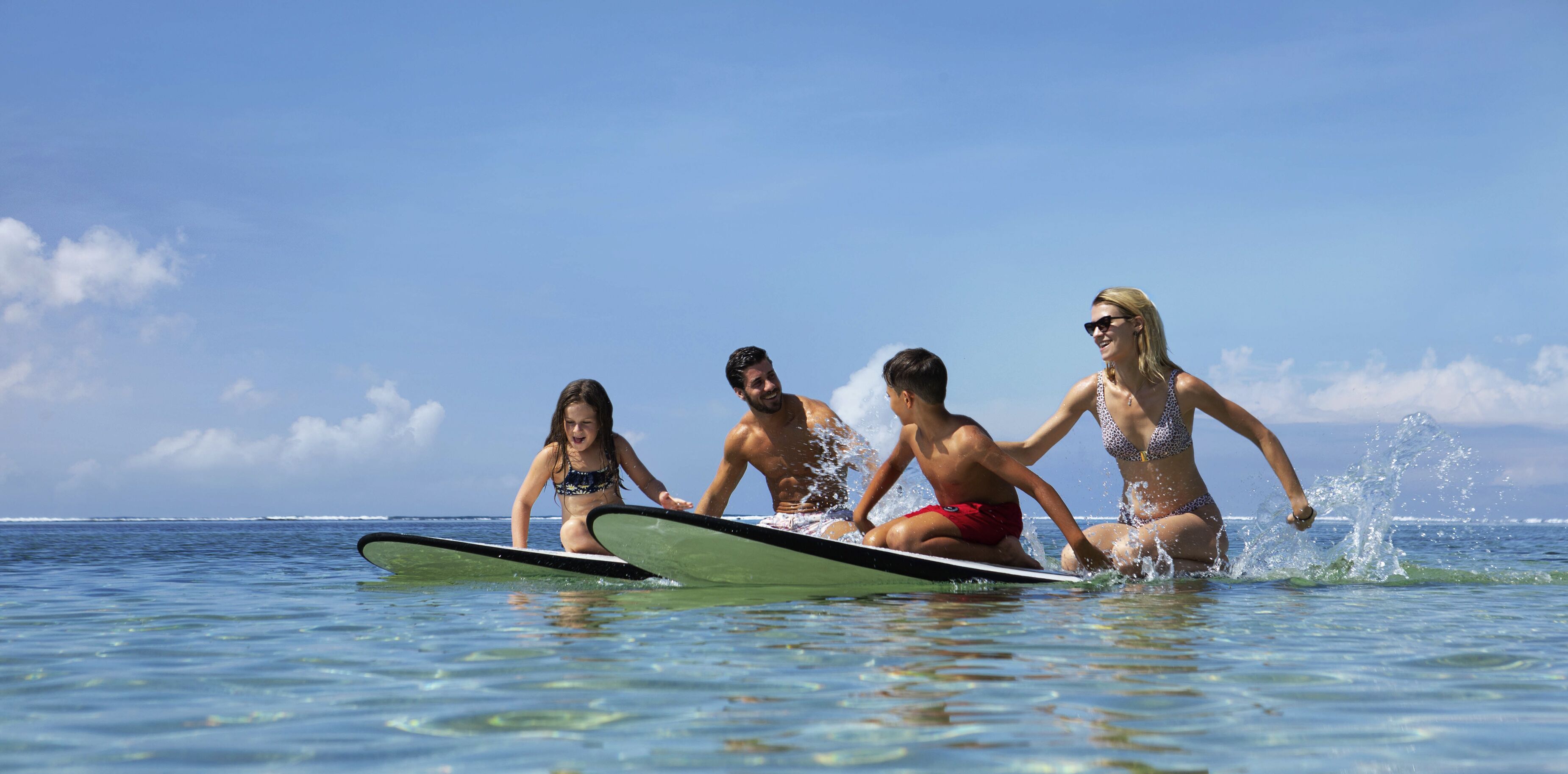 A group of people on surfboards in the ocean.