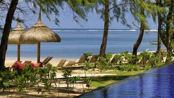 On the beach, white sand, free beach cabanas, sun loungers