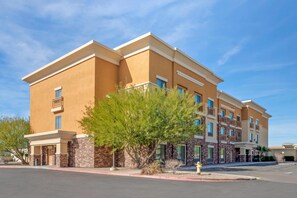 A multi-story hotel with a flat roof, stone facade, and multiple balconies. - Comfort Suites Blythe (Blythe)