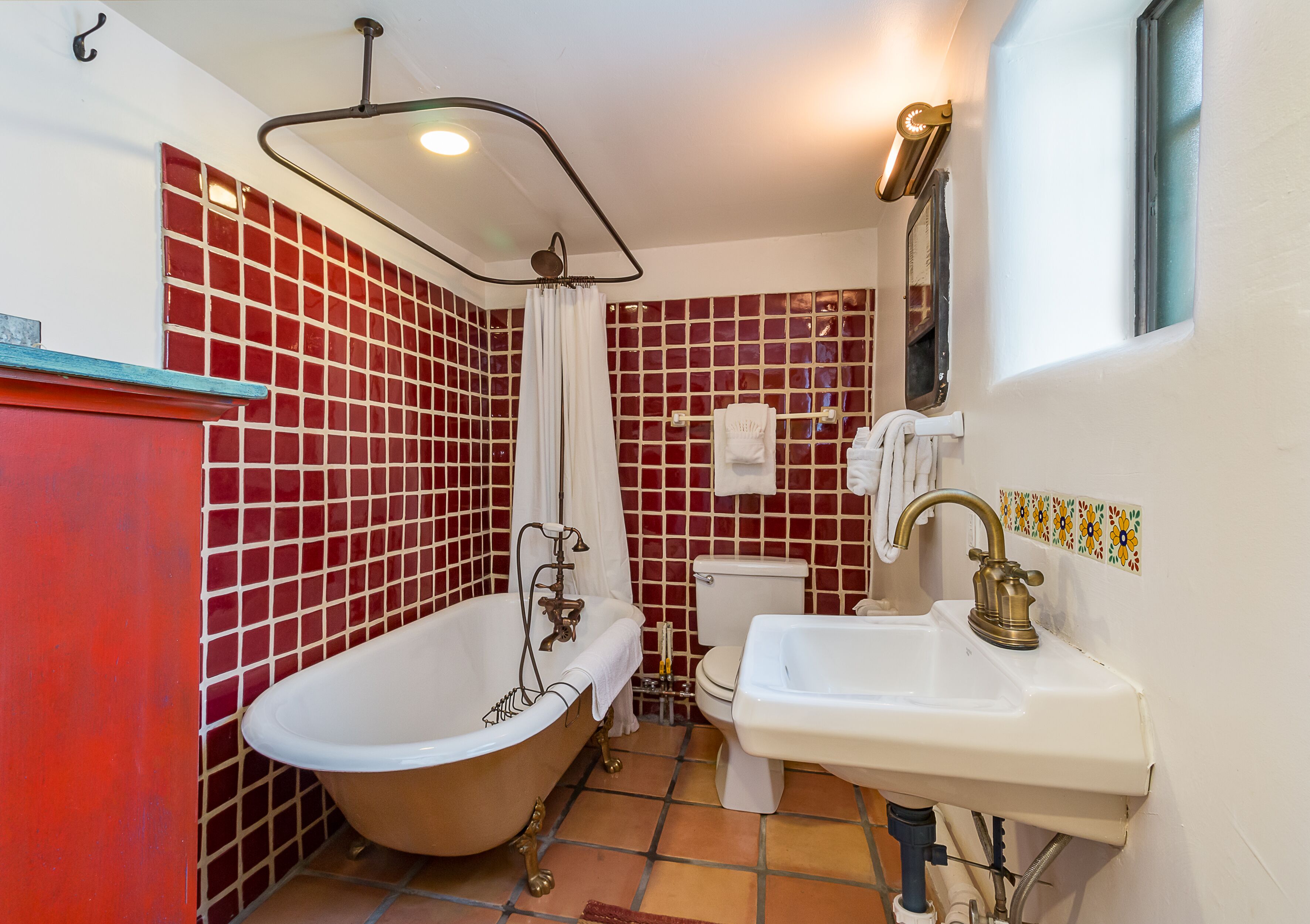 A bathroom with a freestanding bathtub, a sink, and a toilet.