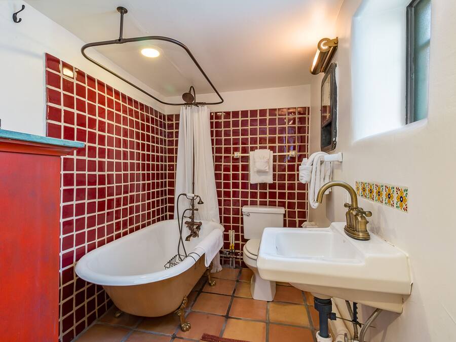 A bathroom with a freestanding bathtub, a sink, and a toilet.