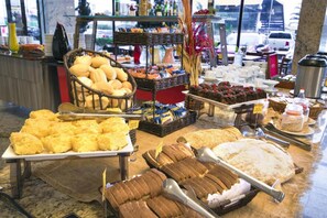 A buffet with various food items including bread, pastries, and desserts. - Hotel Dan Inn Campinas Anhanguera By Nacional Inn (Campinas)
