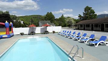 Seasonal outdoor pool, a heated pool, open 8 AM to 10 PM, pool umbrellas