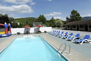 Seasonal outdoor pool, a heated pool, open 8 AM to 10 PM, pool umbrellas