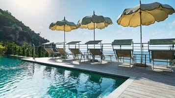 Outdoor pool, open 10 AM to 7 PM, pool umbrellas, sun loungers