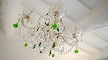 A chandelier with clear glass elements and green accents.