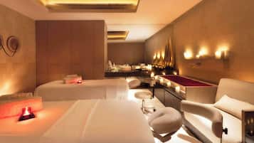 Relax in a serene space with a plush bed, armchairs, and a convenient table.
