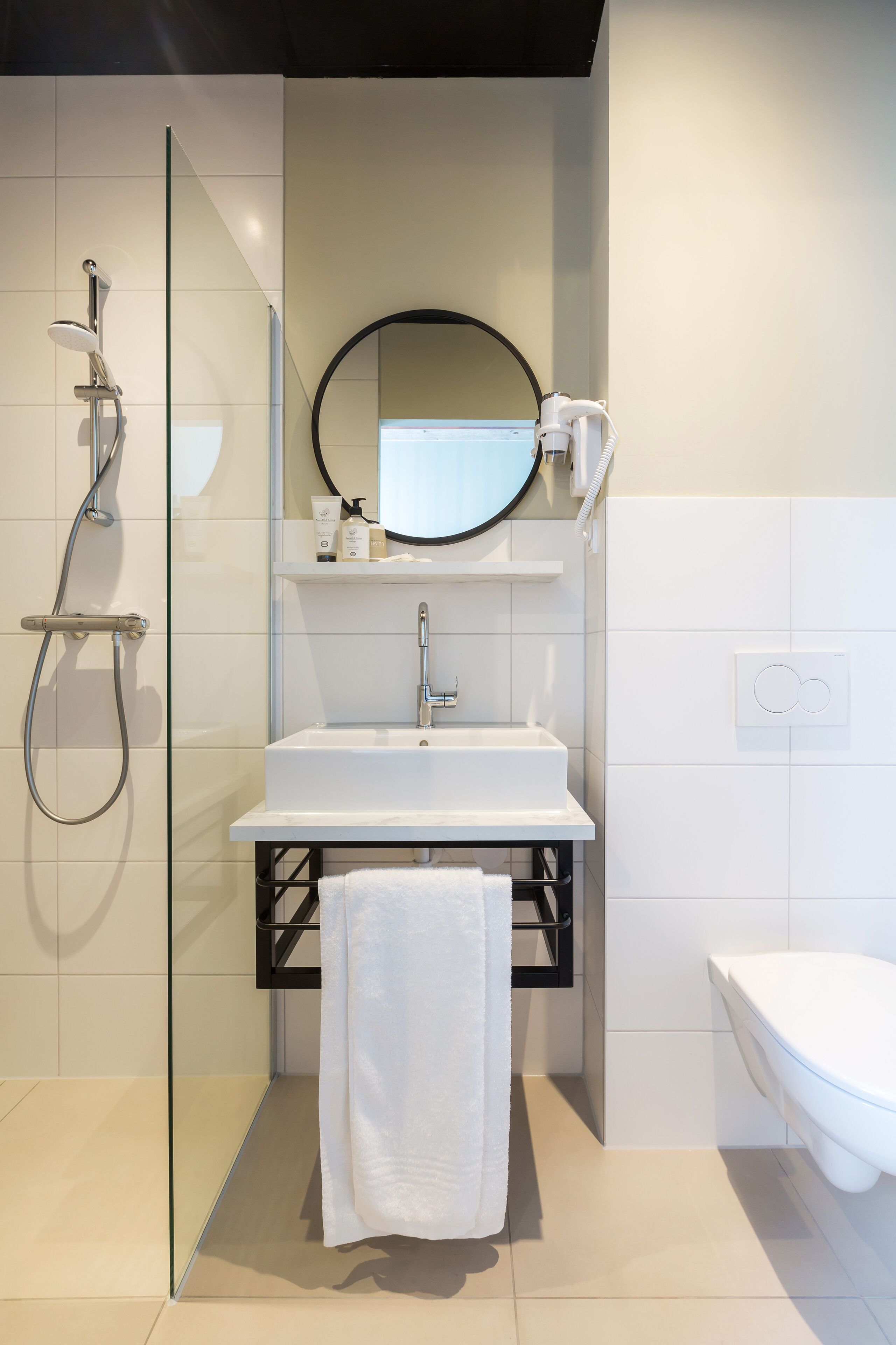 designer toiletries, hair dryer, towels, soap