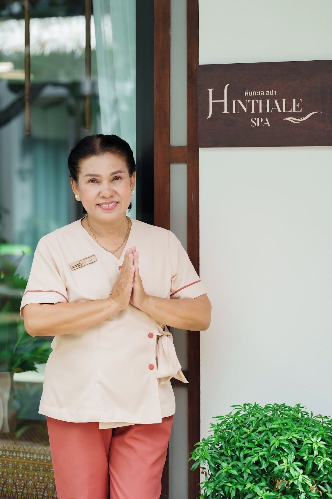 A person standing in front of a spa entrance with a sign that reads "HINTHALE SPA".