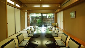 A conference room with a long table, chairs, and a view of greenery outside. - Kyoto Garden Palace (Kyoto)