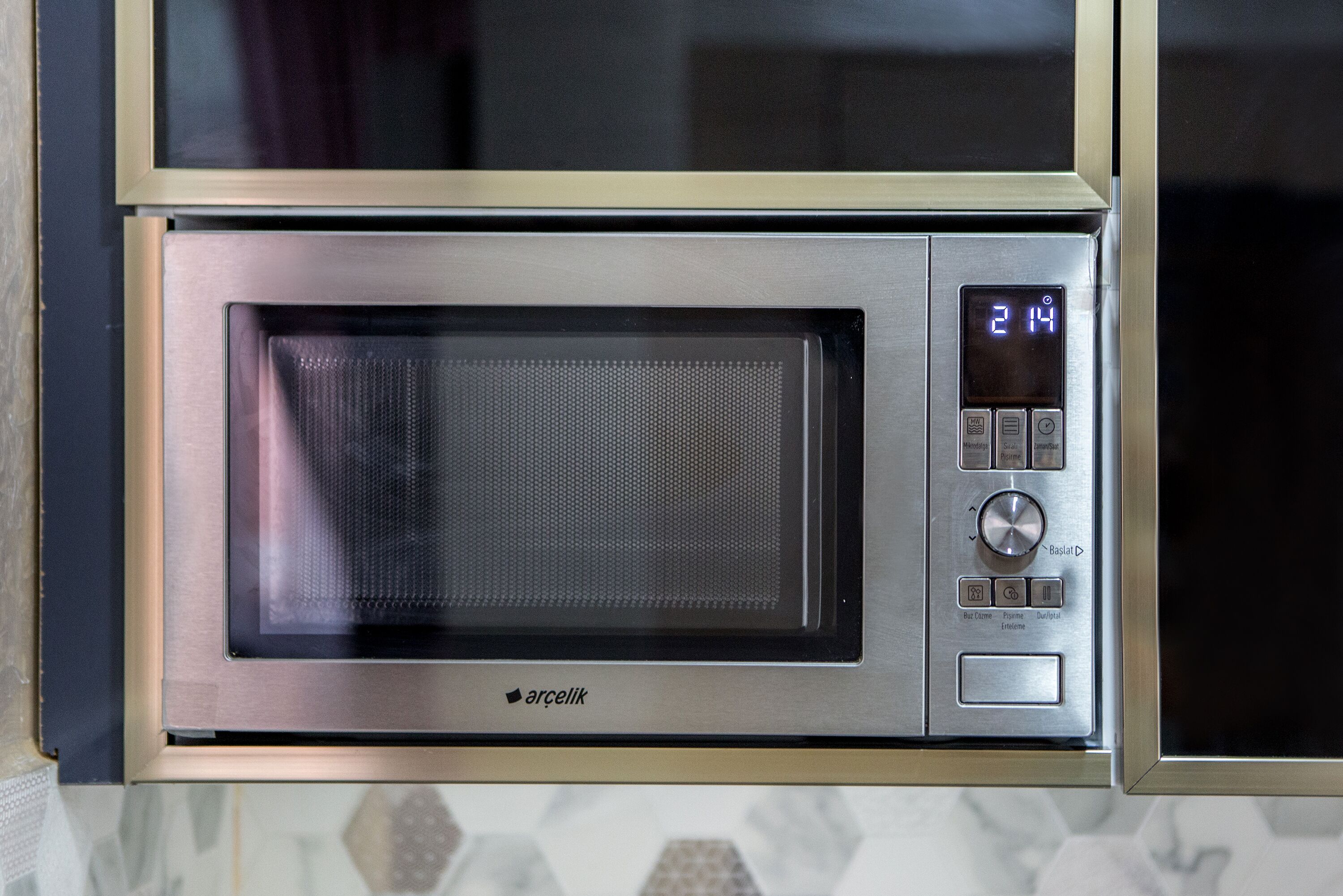 A microwave oven with a digital display and control buttons.