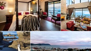 A bedroom with a four-poster bed, a sitting area with a fireplace, and a balcony with a view of the sea. - Mariner Guesthouse (Cape Town)