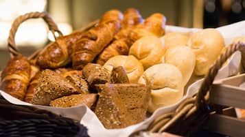 A variety of breads and pastries in a basket.