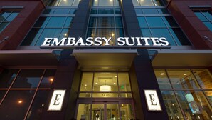 The exterior of the Embassy Suites hotel with a prominent sign and the address 1420. - Embassy Suites by Hilton Denver Downtown Convention Center (Denver)