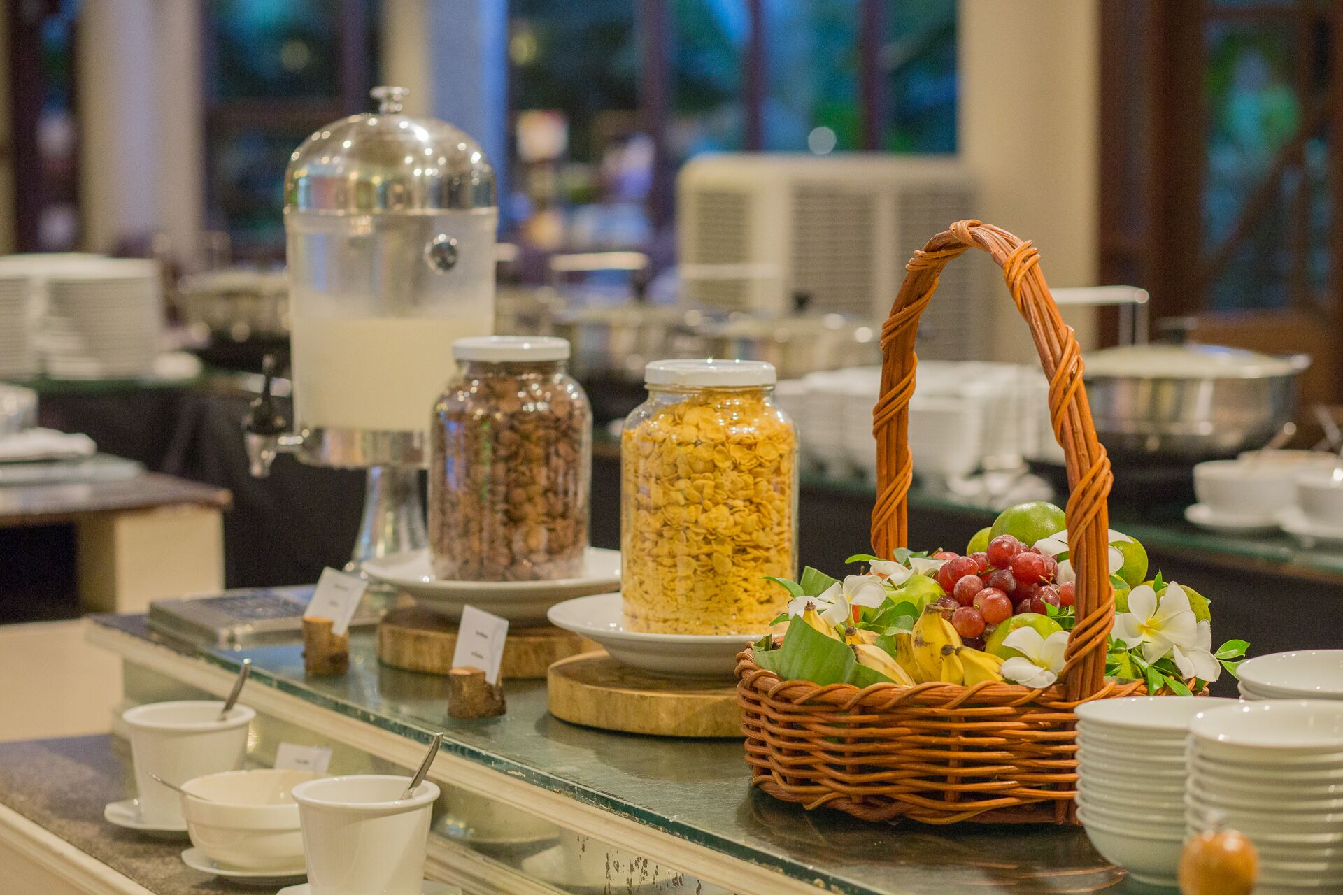 A buffet setup with various food items and a decorative basket.