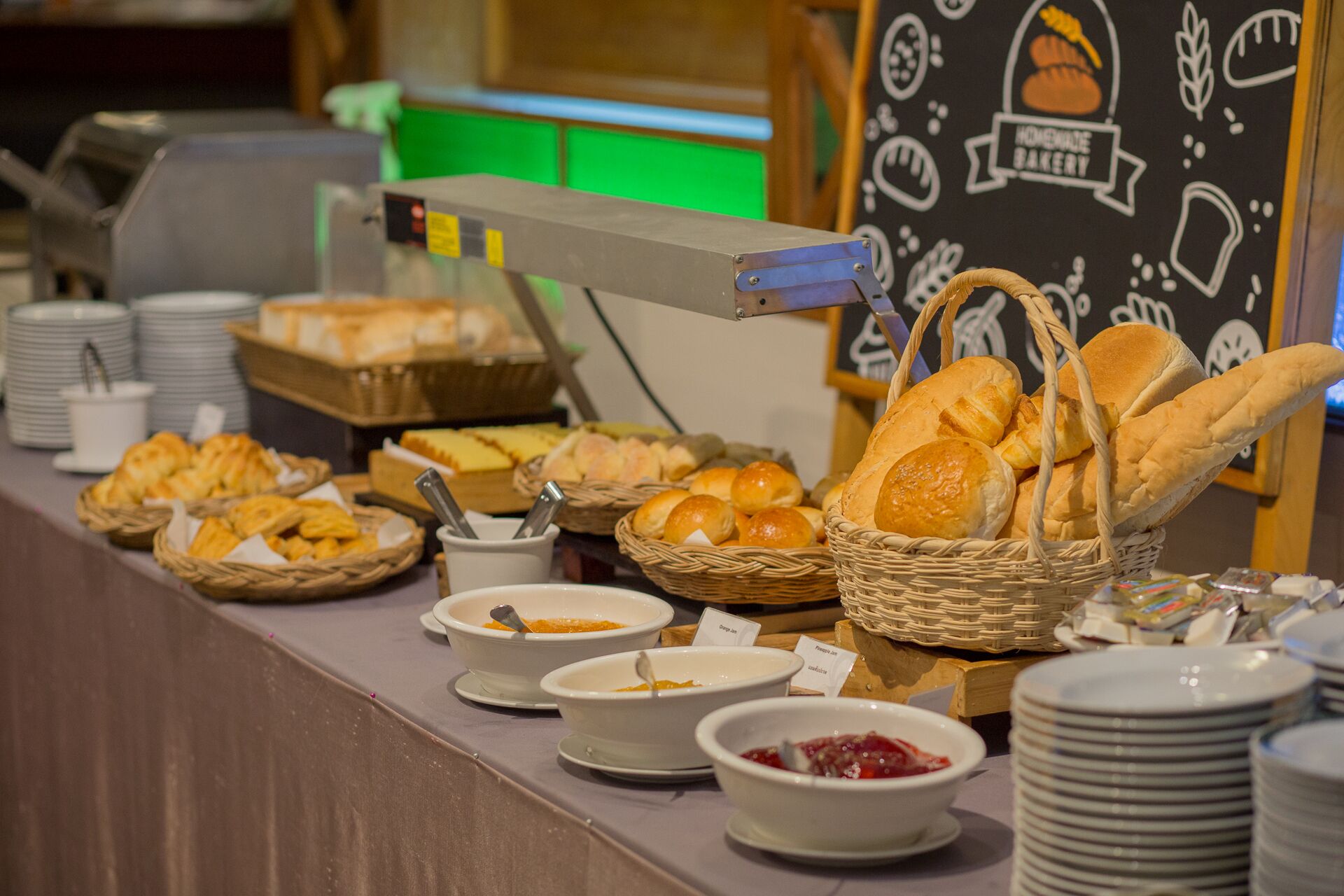 A buffet with various breads and dips.