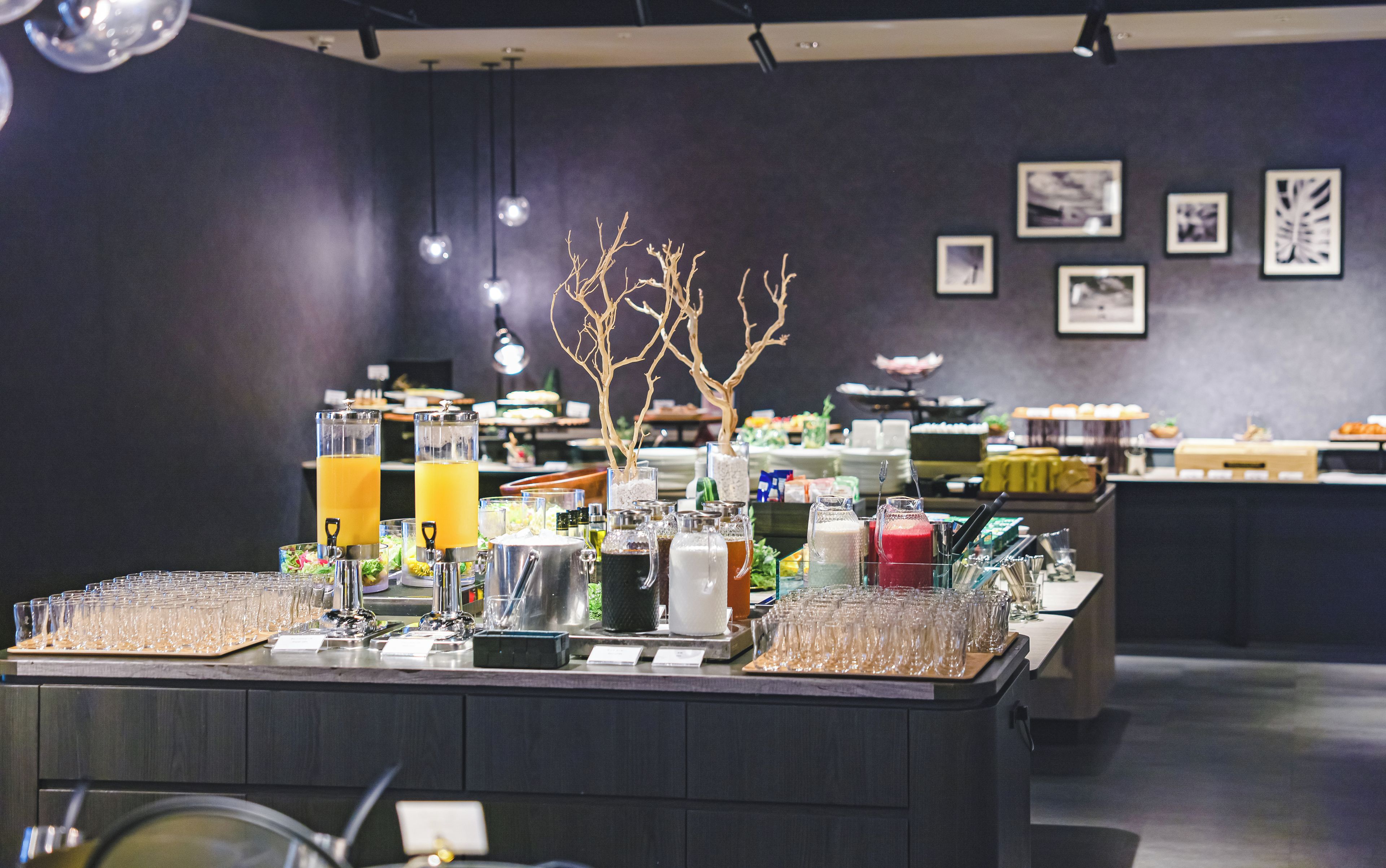 A buffet setup with various food items and beverages.