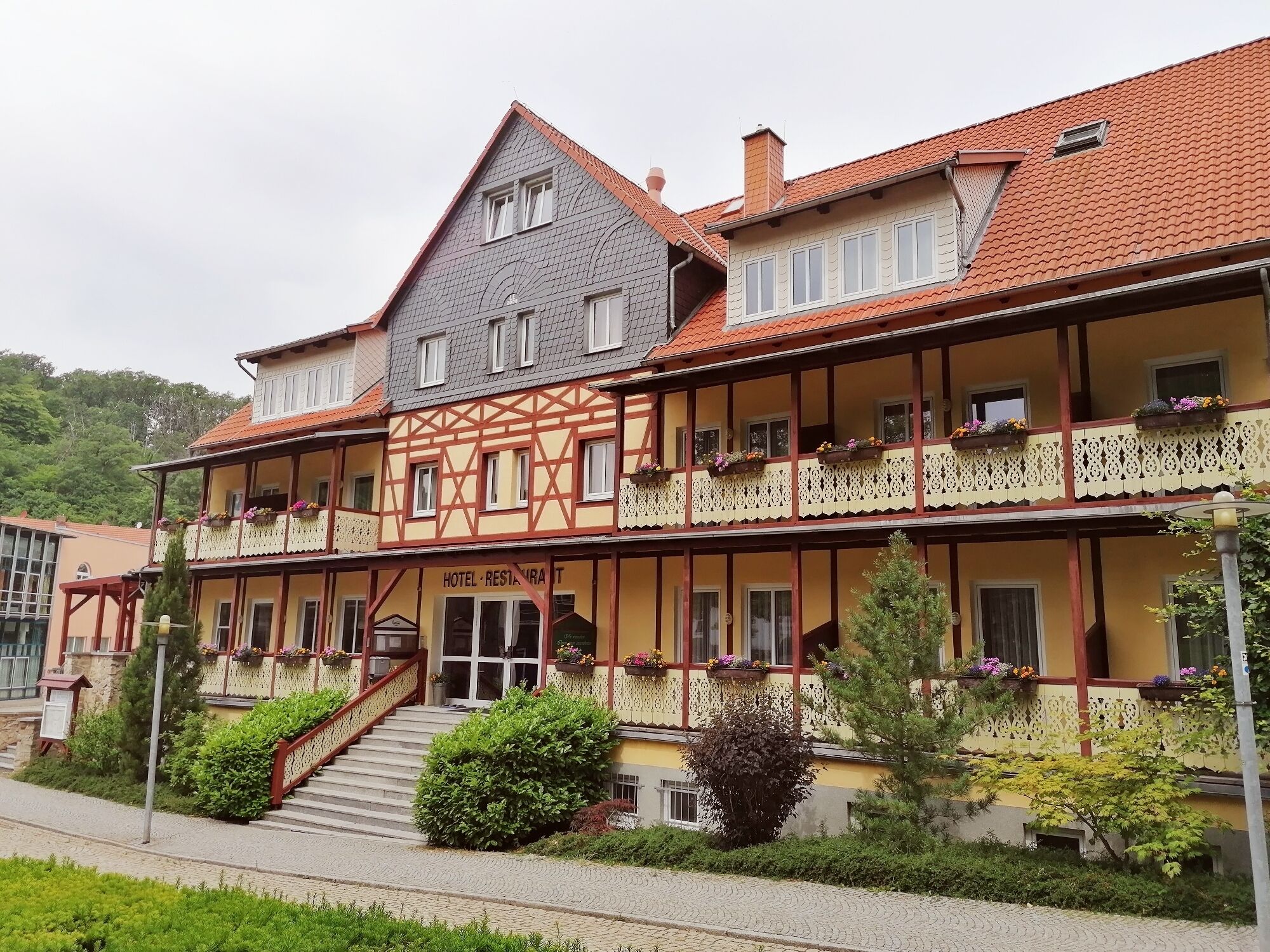 A traditional half-timbered building with a sign reading "HOTEL RESTAURANT".