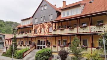 A traditional half-timbered building with a sign reading "HOTEL RESTAURANT".