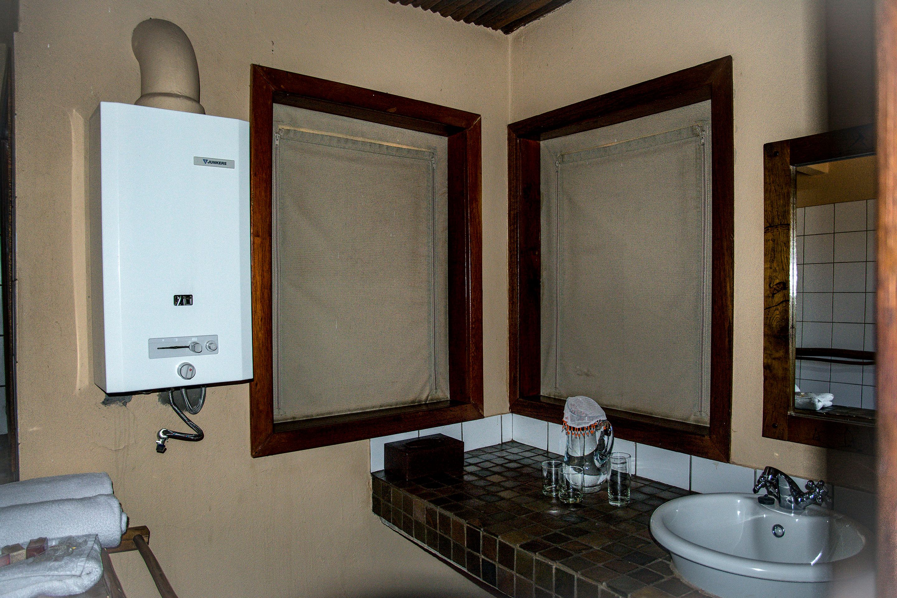 A bathroom with a white sink, a mirror, and a towel rack.