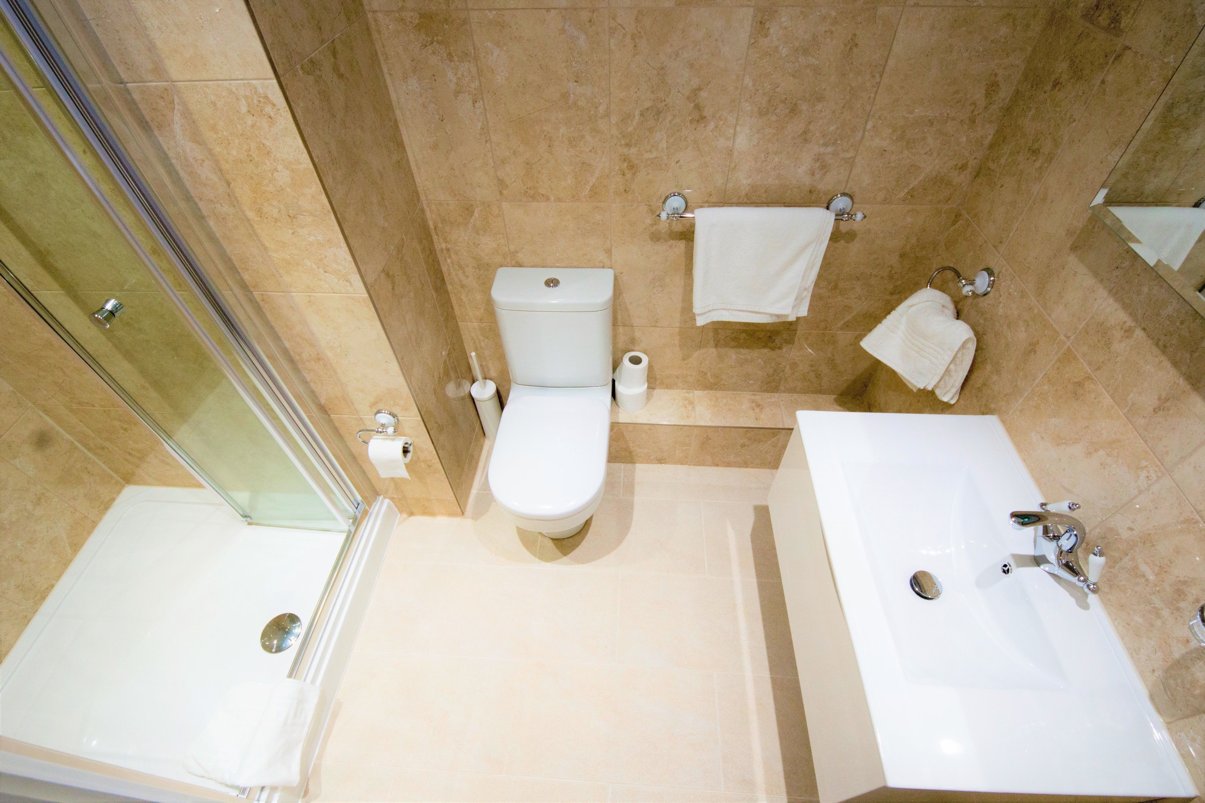A bathroom with a bathtub, toilet, and sink.