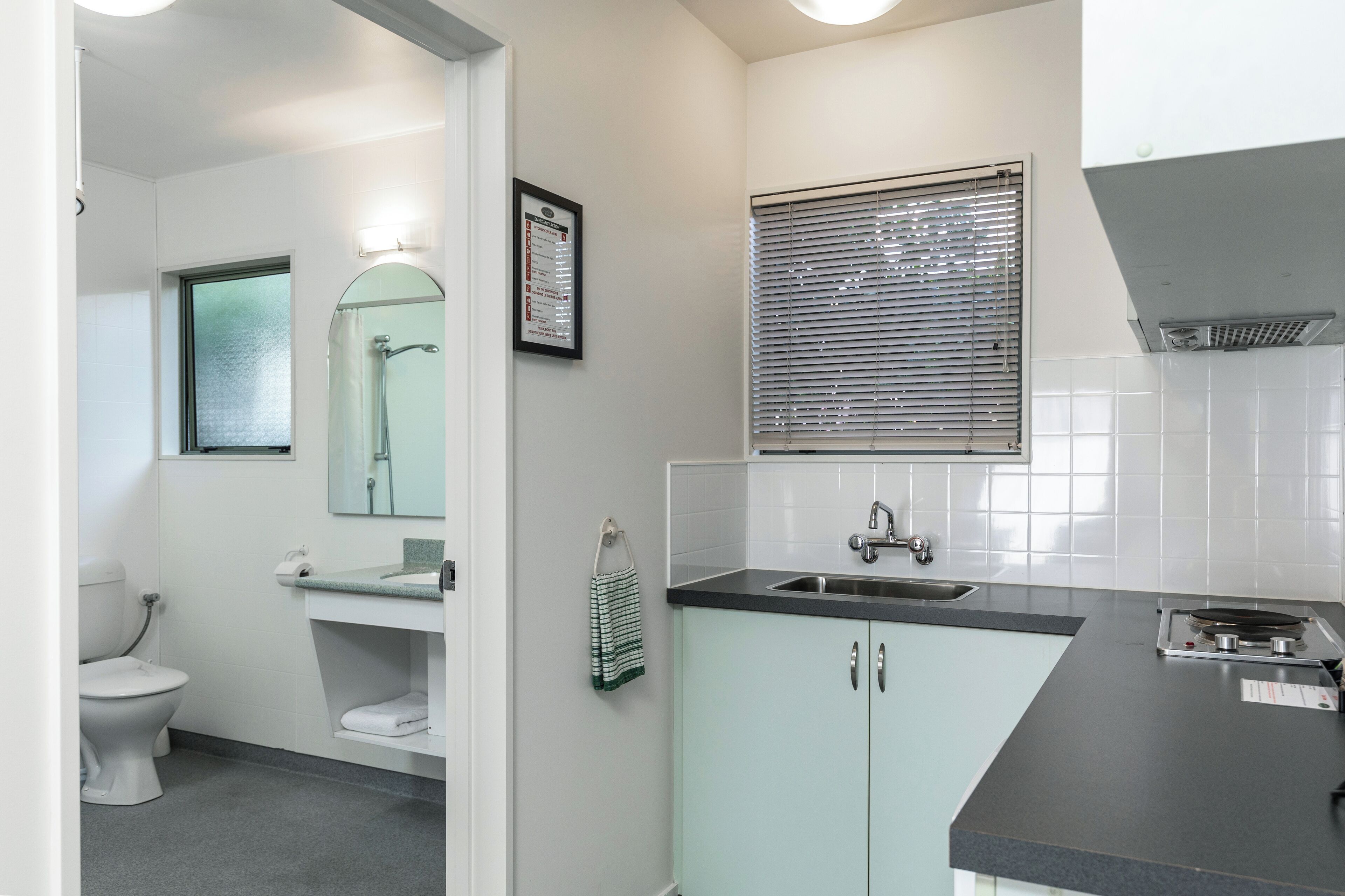 A modern bathroom with a toilet, sink, and shower.