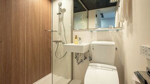 A bathroom with a shower, toilet, sink, and a mirror above the sink. - Sendai Garden Palace (Sendai)