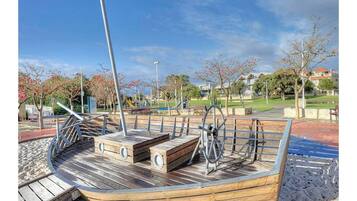 Enjoy a leisurely stroll around this charming boat-shaped structure, featuring a central seating area and a unique wheel element.