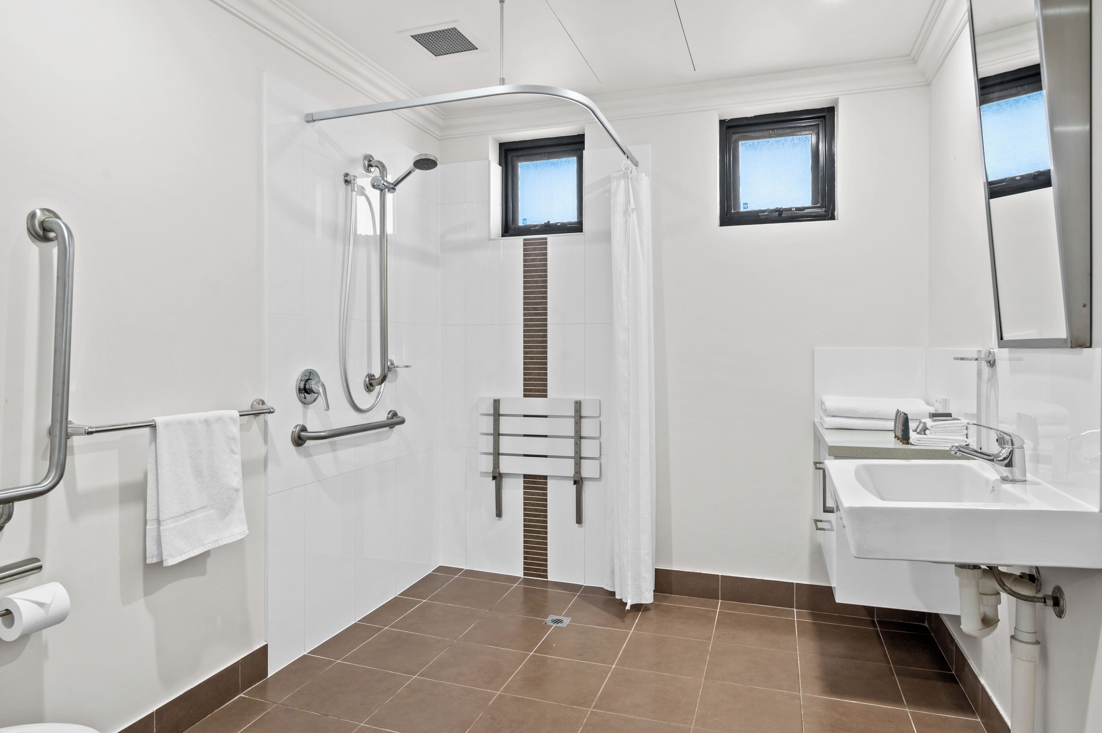 Un baño moderno con ducha, inodoro y lavabo.