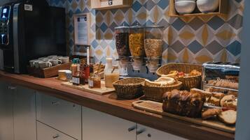 A breakfast buffet with various food items and condiments.