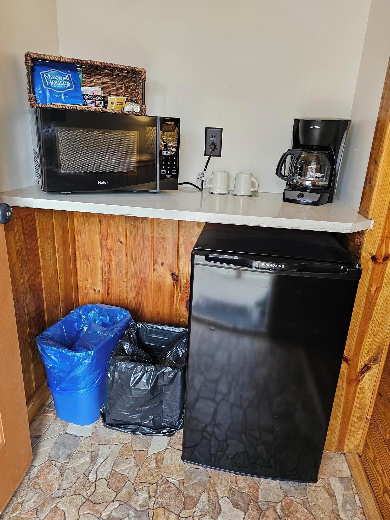 A compact kitchenette with a microwave, coffee maker, and a mini fridge.