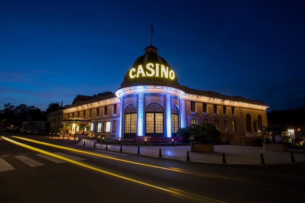 A building with a prominent dome labeled 'CASINO' and a well-lit entrance.