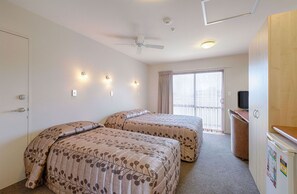 Desk, laptop workspace, blackout drapes, iron/ironing board