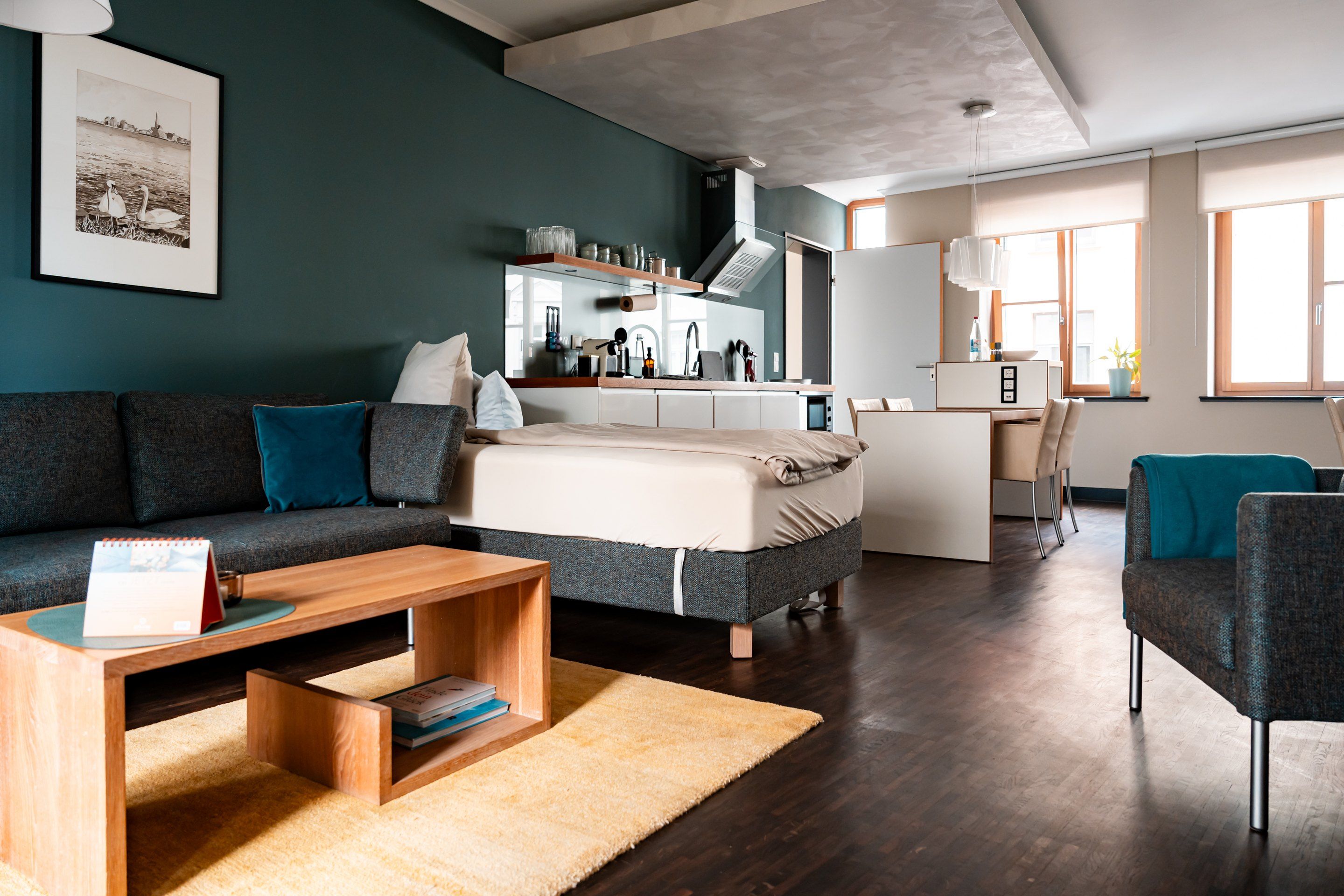 A modern living room with a sofa, a coffee table, and a rug.