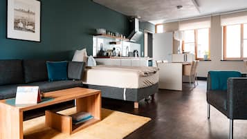 A modern living room with a sofa, a coffee table, and a rug.