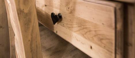 A wooden drawer with a heart-shaped handle.