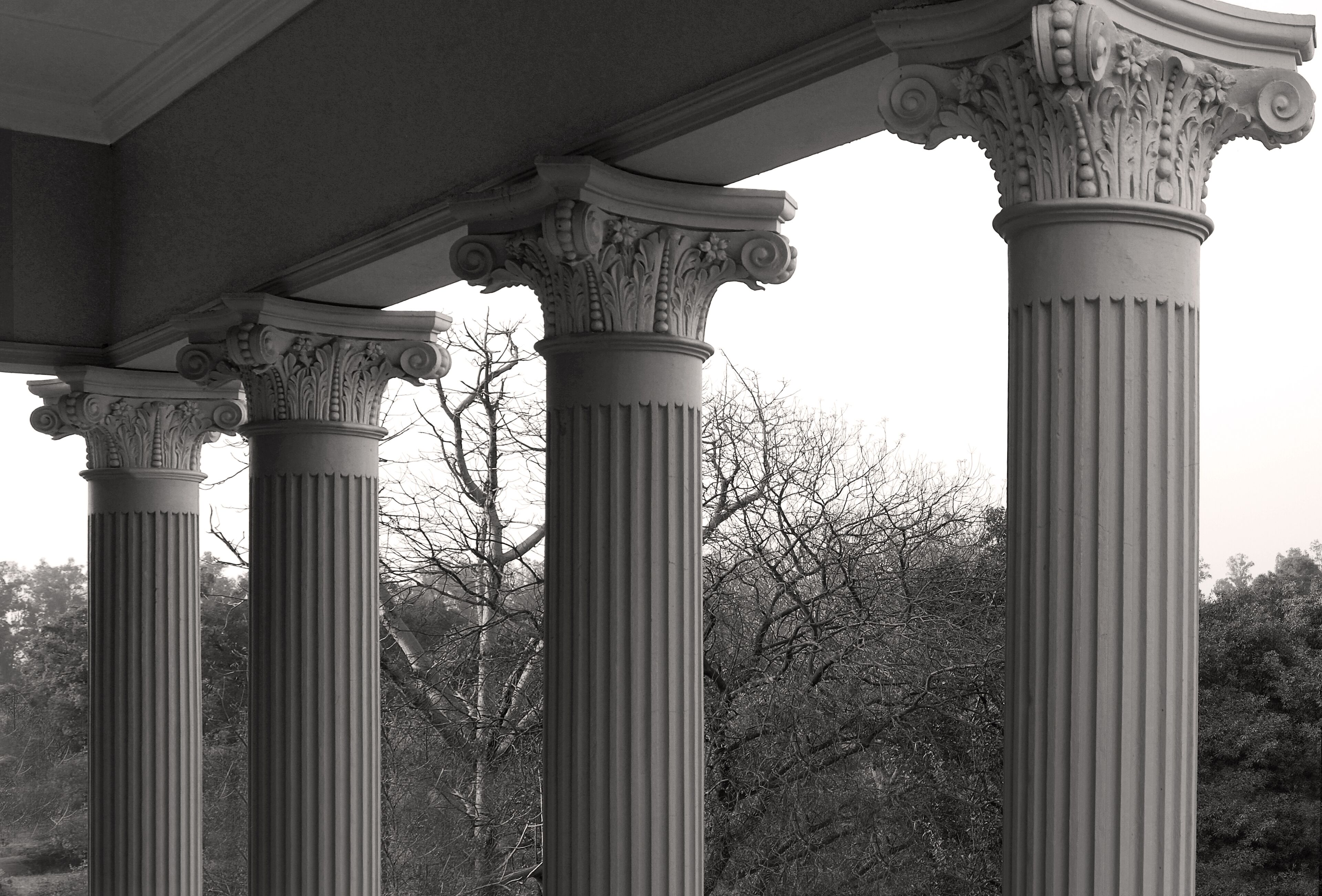 A classical architectural structure with ornate columns and a detailed entablature.
