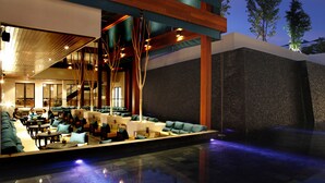 Un área de piscina interior moderna con asientos y una escalera.