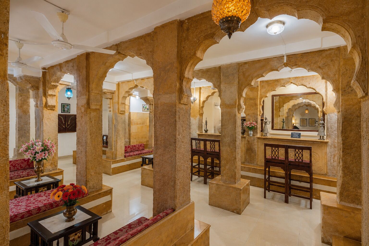 A lobby with ornate arches, seating areas, and a reception desk.