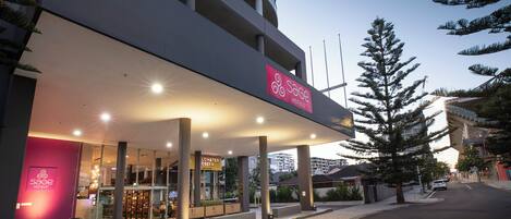 A hotel with a modern design, featuring a prominent sign for Sage Hotels.