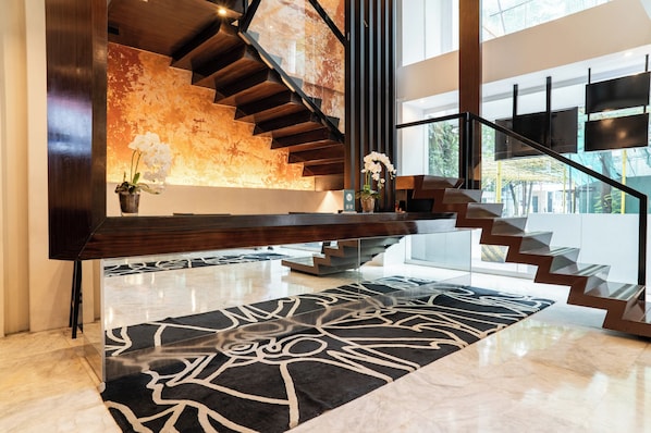 A modern interior with a wooden staircase, a marble floor, and a large window. - The Picasso Boutique Serviced Residences (Makati)