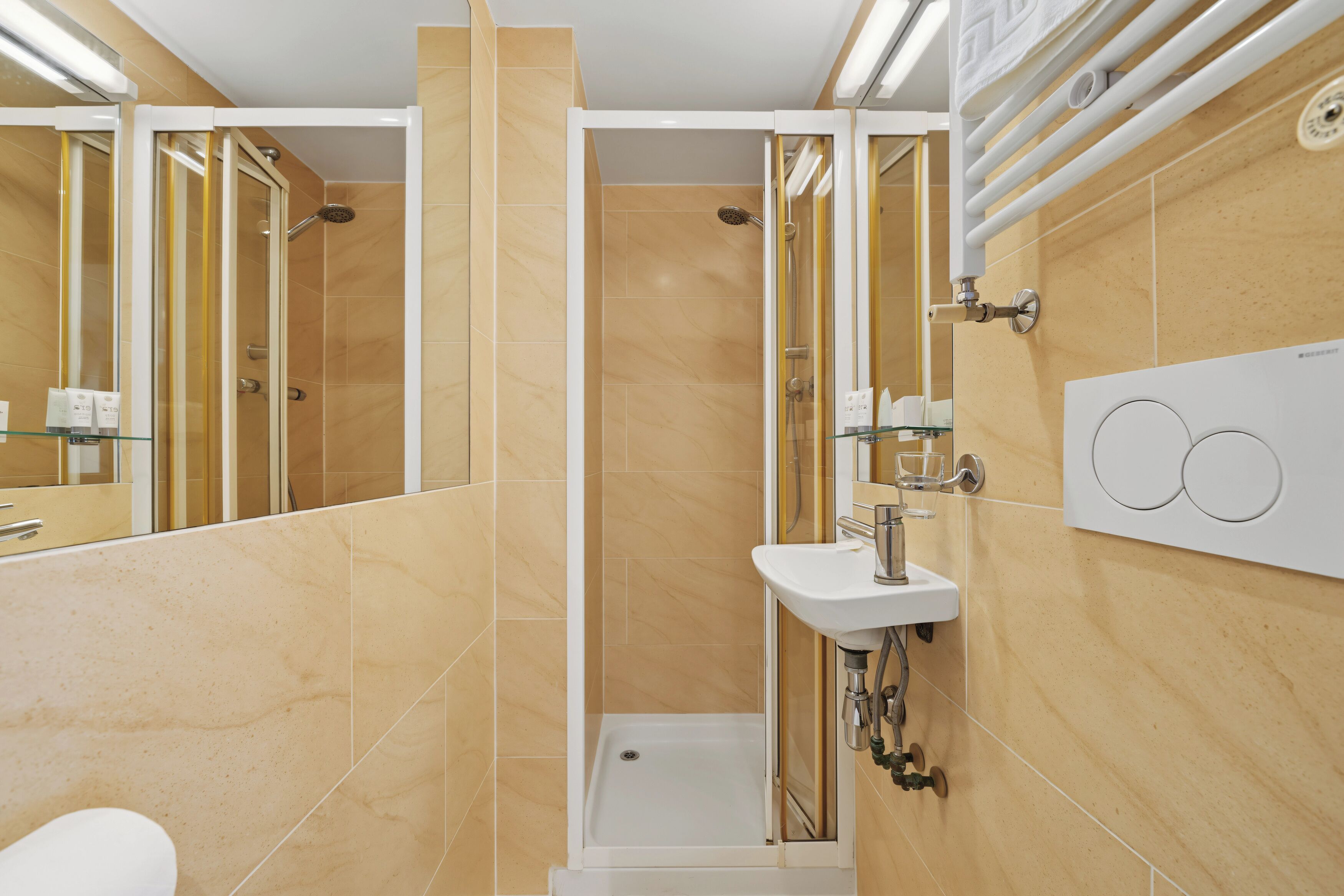 A modern bathroom with a shower, a sink, and a mirror.