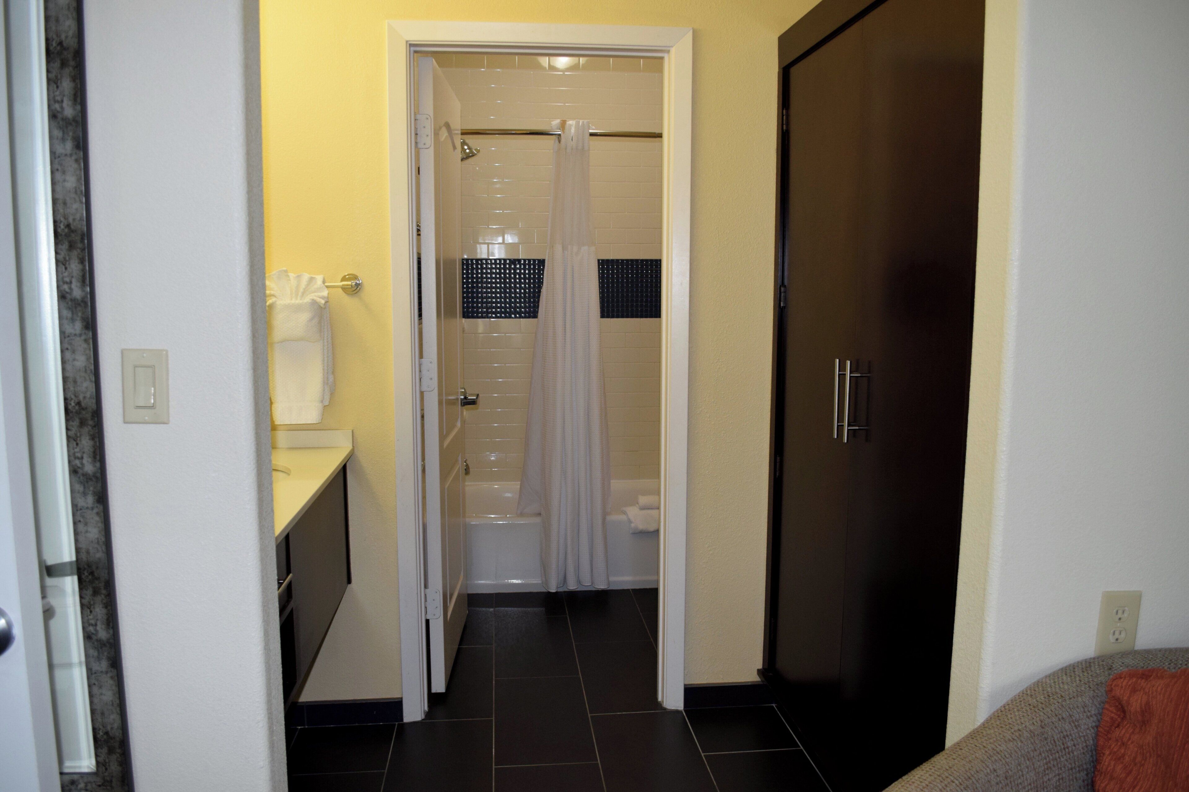 A bathroom with a shower, toilet, and sink.