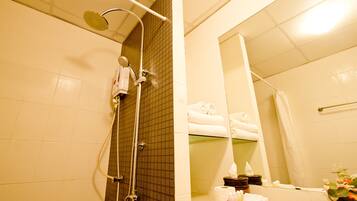 A bathroom with a shower, a sink, and a mirror.