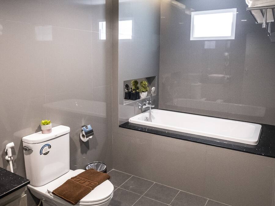 A modern bathroom with a toilet, sink, and bathtub.